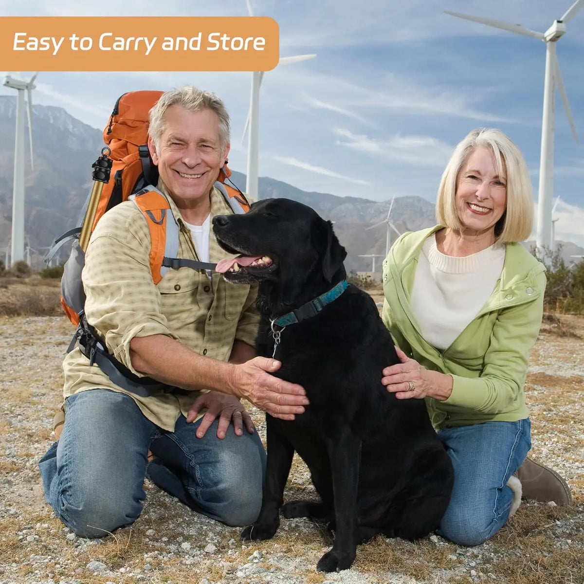Happy older couple outdoors with black dog promoting AmaCielo Flirt Pole easy to carry and store