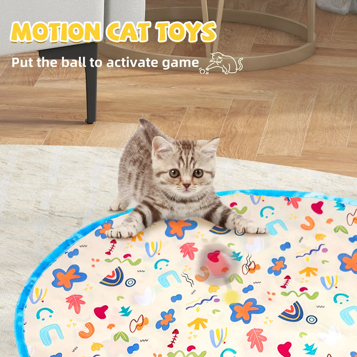 Indoor tabby cat pouncing on a hidden moving object under a mat